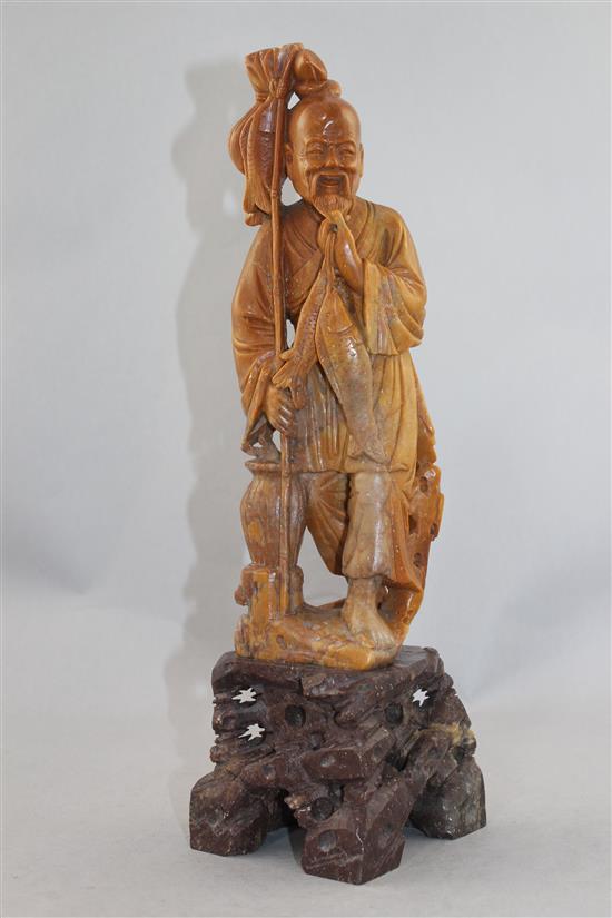 A Chinese soapstone figure of a fisherman, early 20th century, 36cm.